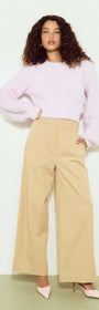 Cropped Baby Pink Fluffy Jumper styled with wide-leg beige pants and high heels, showcasing a chic, casual look.