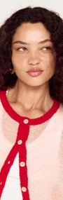 Model wearing Sheer Contrast Trim Pink Cardigan with red trim and buttons, showcasing a playful and elegant style.