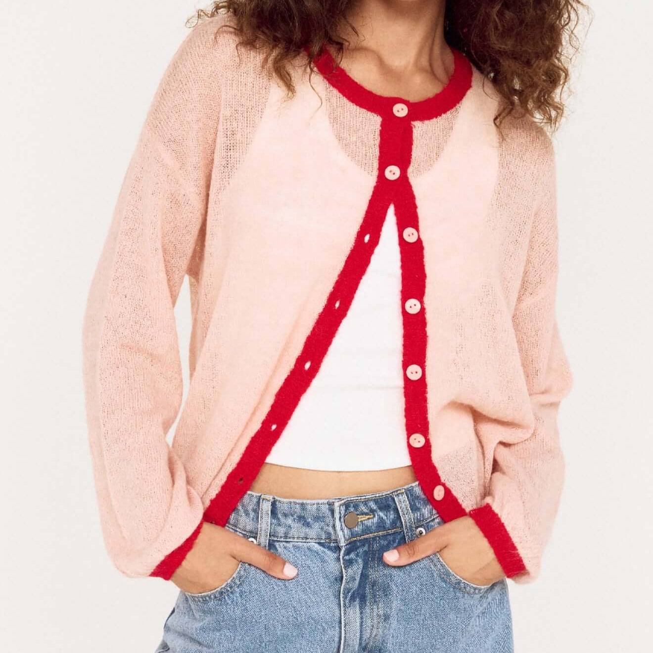 Sheer Contrast Trim Pink Cardigan worn by model, featuring playful colors and soft fabric for a stylish look.