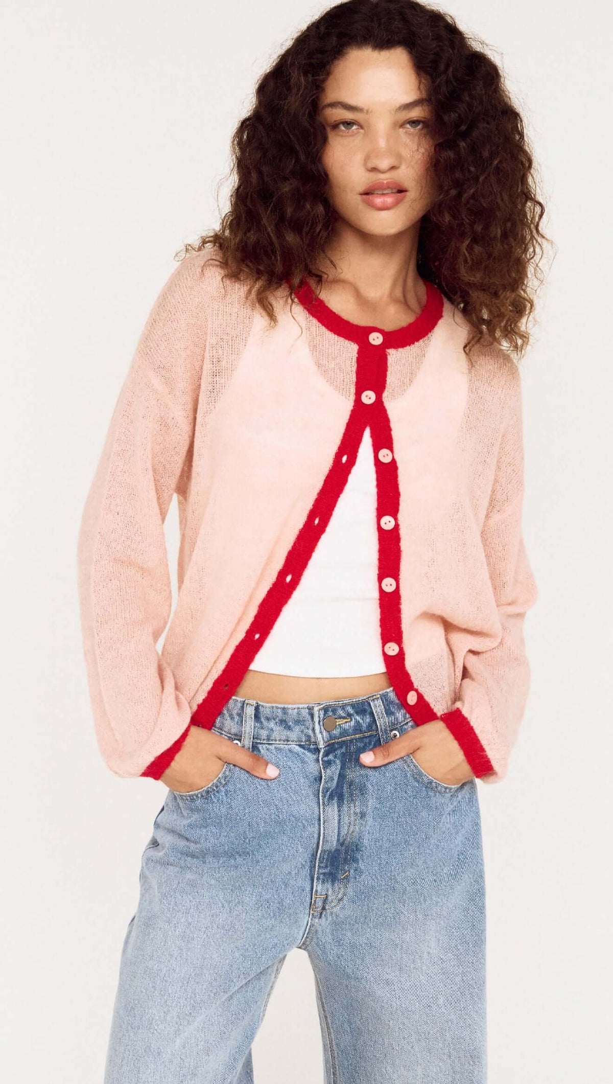 Sheer Contrast Trim Pink Cardigan worn by model, featuring playful colors and soft fabric for a stylish look.