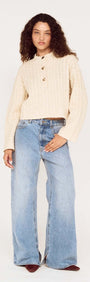 Fine Cable Knit Top with Gold Detail worn with relaxed denim, showcasing a stylish cropped silhouette and button details.