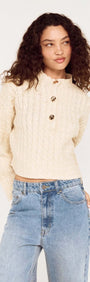 Fine Cable Knit Top with Gold Detail, featuring a high neckline and statement buttons, styled with relaxed denim.