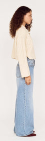 Model wearing a Fine Cable Knit Top with Gold Detail styled with relaxed denim for a modern look.