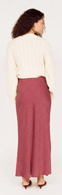 Cream Relaxed Fit Cable Knit Jumper paired with a striped red midi skirt, viewed from the back.