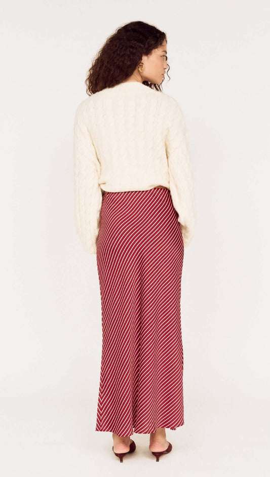 Cream Relaxed Fit Cable Knit Jumper paired with a striped red midi skirt, viewed from the back.