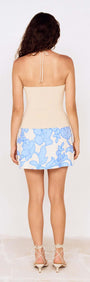 Back view of the Cream Bead Detail Knitted Halter Top showing its fitted design and floral skirt.