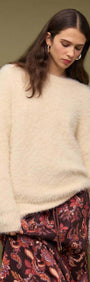Model wearing a Cream oversized Fluffy Knit Sweater styled with patterned pants, against a neutral background.