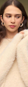 Cream oversized Fluffy Knit Sweater being worn, showcasing its cozy, fluffy texture and relaxed fit.
