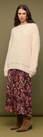 Model wearing a Cream oversized Fluffy Knit Sweater with a floral skirt, showcasing a relaxed winter outfit.