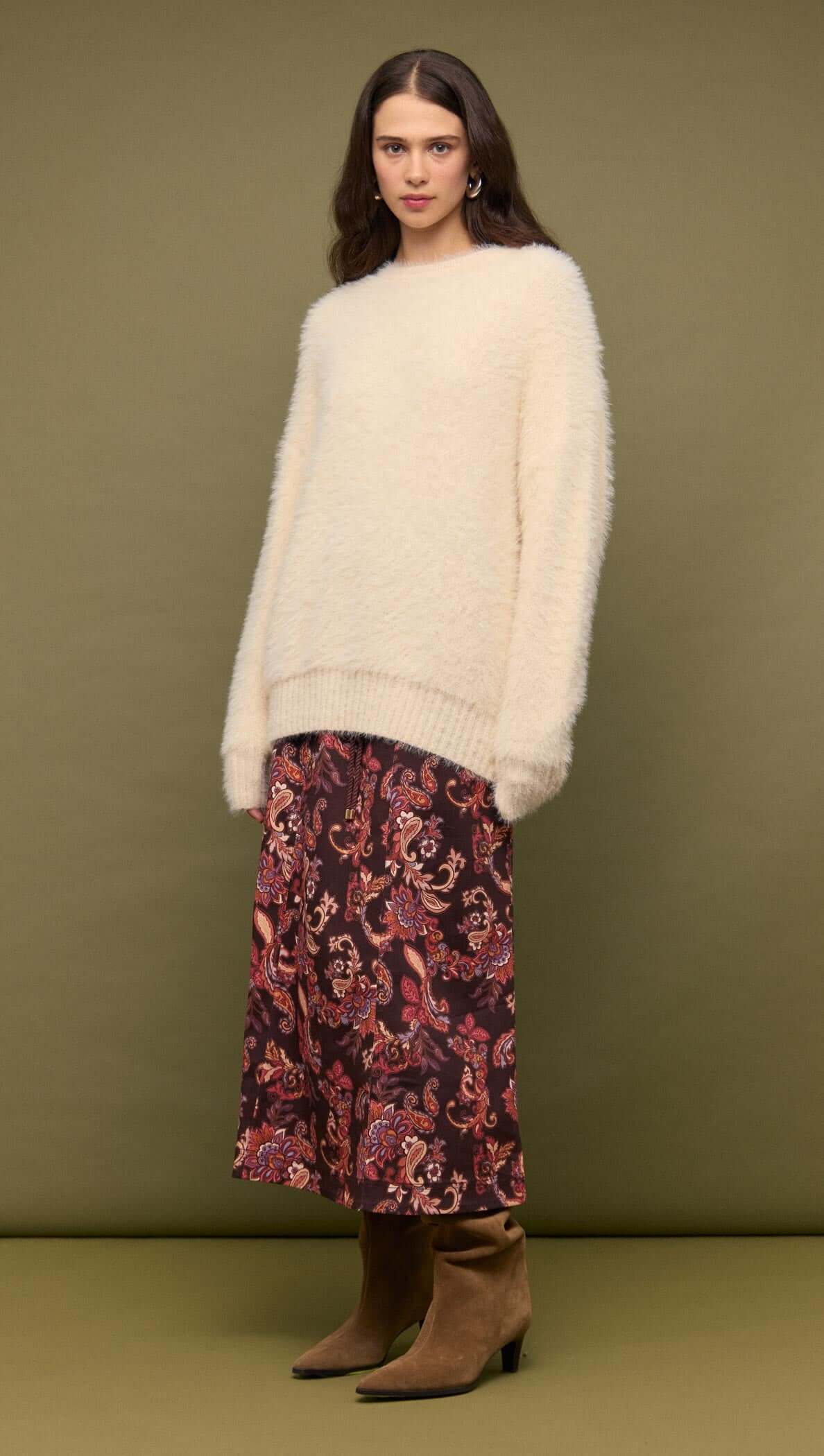 Model wearing a Cream oversized Fluffy Knit Sweater with a floral skirt, showcasing a relaxed winter outfit.