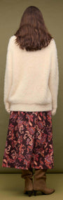 Back view of a model wearing a Cream oversized Fluffy Knit Sweater with a floral skirt.