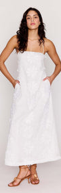 White Cotton Floral Applique Lace-Back Maxi Dress on model with pockets and delicate straps, perfect for summer.