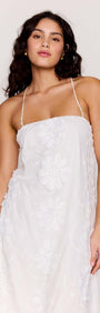 White Cotton Floral Applique Lace-Back Maxi Dress on a model, showcasing intricate floral details and a romantic silhouette.