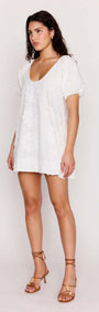 White Cotton Floral Applique Smock Mini Dress featured on a model, showcasing relaxed fit and puff sleeves.