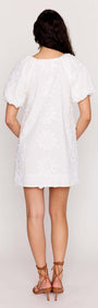 Back view of the White Cotton Floral Applique Smock Mini Dress featuring puff sleeves and delicate floral details.