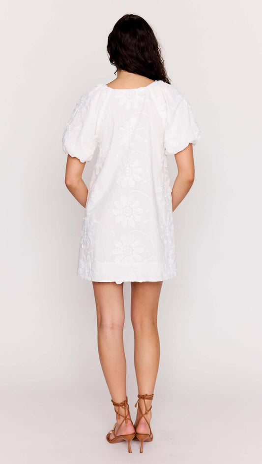 Back view of the White Cotton Floral Applique Smock Mini Dress featuring puff sleeves and delicate floral details.