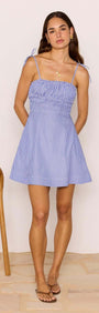 Model wearing a Blue & White Stripe Mini Dress with tie straps and flared skirt, perfect for summer outings.