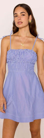 Blue & White Stripe Mini Dress on model featuring a fitted shirred bust and tie straps.