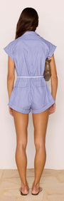 Back view of a model wearing the Blue & White Stripe Playsuit with a detachable belt and rolled sleeves.