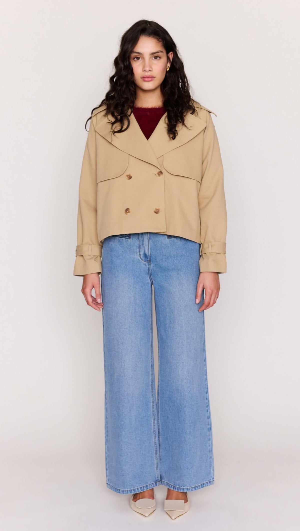 Beige Cotton Drill Cropped Trench styled with wide-leg denim and heels, showcasing a modern, structured design.