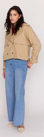 Model wearing a Beige Cotton Drill Cropped Trench paired with wide-leg jeans.