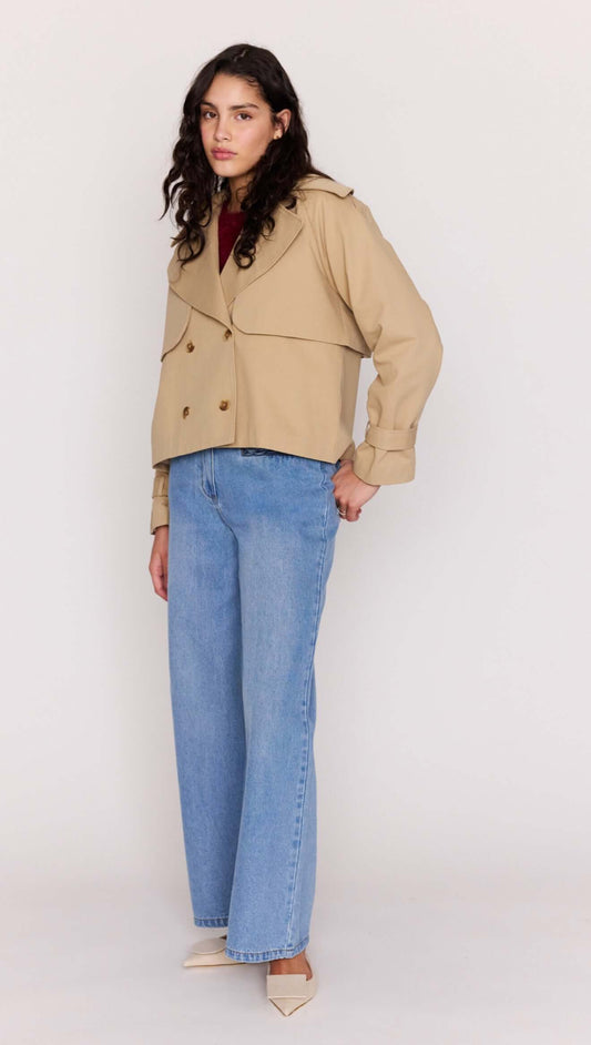 Model wearing a Beige Cotton Drill Cropped Trench paired with wide-leg jeans.