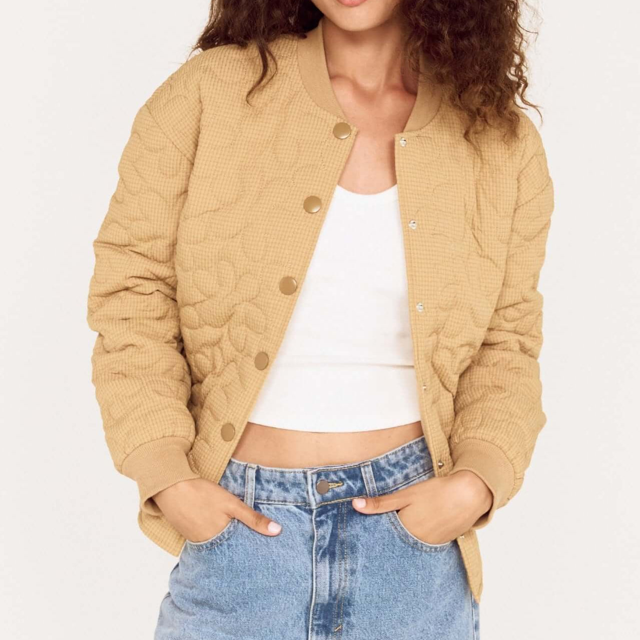 Beige Floral Quilted Puffer Jacket worn by a model, featuring a relaxed fit and soft quilted texture.