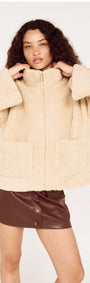 Woman wearing a Beige Teddy Jacket with High Collar over a brown skirt, showcasing a stylish winter outfit.