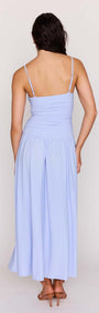 Back view of a woman wearing the Powder Blue Mesh Drop Waist Maxi Dress with ruched bodice, showcasing the skirt.