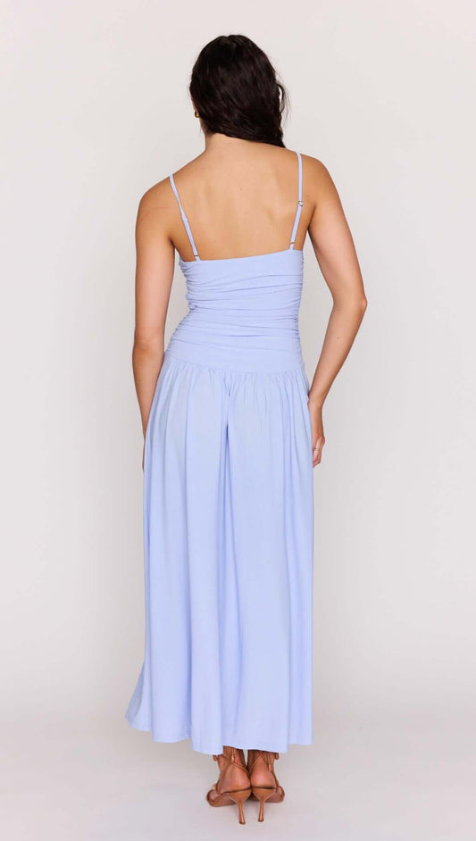Back view of a woman wearing the Powder Blue Mesh Drop Waist Maxi Dress with ruched bodice, showcasing the skirt.
