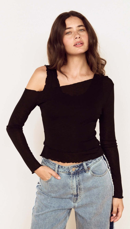 Model wearing a Black Asymmetric Layered Mesh Top with denim jeans, showcasing its stylish design and cropped hem.