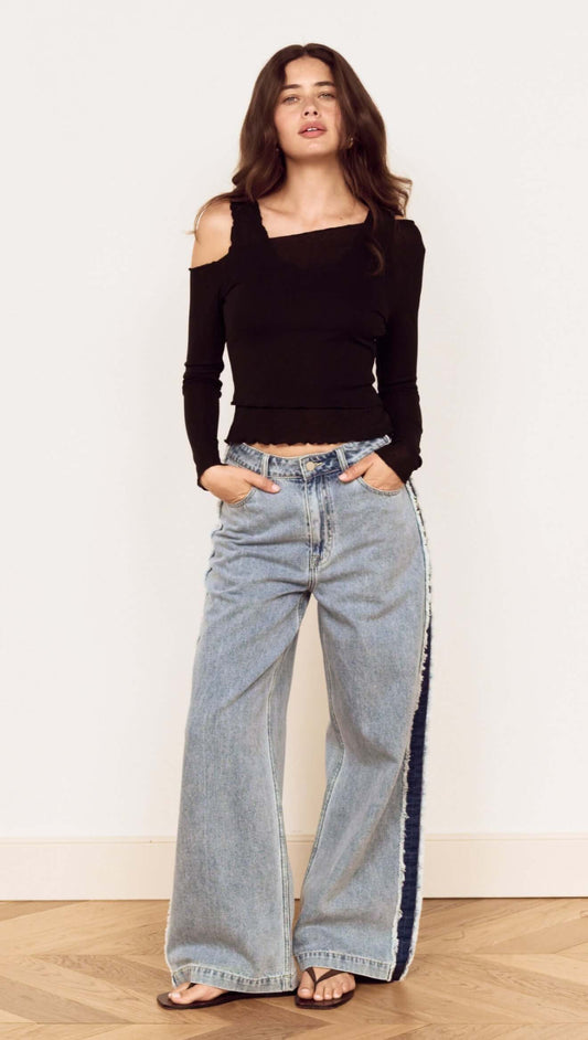 Model wearing Black Asymmetric Layered Mesh Top with wide leg jeans and sandals.
