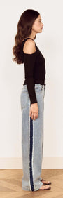 Model showcasing the Black Asymmetric Layered Mesh Top paired with denim, highlighting its stylish asymmetric design.