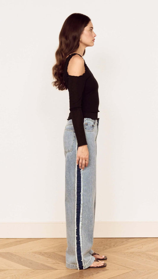 Model showcasing the Black Asymmetric Layered Mesh Top paired with denim, highlighting its stylish asymmetric design.
