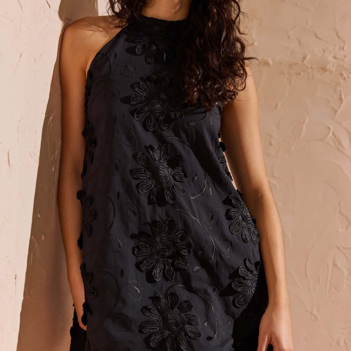 Black Cotton Applique High Neck Mini Dress in black with floral applique detail on a model.