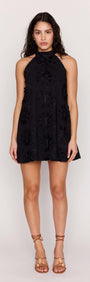 Black Cotton Applique High Neck Mini Dress worn by model, showcasing its floral design and halter neckline.