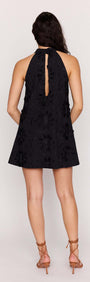 Back view of the Black Cotton Applique High Neck Mini Dress showcasing the halter neckline and floral detailing.