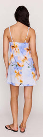 Back view of a model wearing a Blue Floral Linen Blend Shift Mini Dress showcasing its elegant floral pattern.