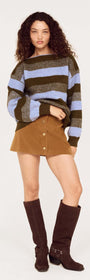 Model wearing a Blue Stripe Soft Boat Neck Jumper paired with a brown skirt and tall boots, showcasing a casual autumn look.