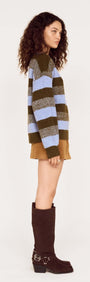 Model wearing a Blue Stripe Soft Boat Neck Jumper with green and blue stripes, styled with a short skirt and knee-high boots.