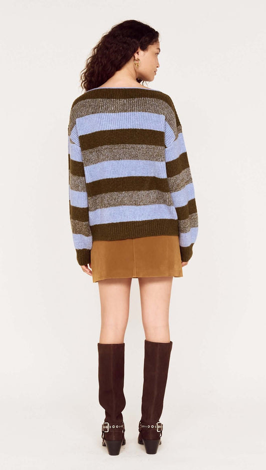 Back view of a model wearing a Blue Stripe Soft Boat Neck Jumper paired with a brown skirt and knee-high boots.