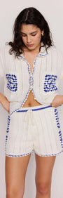 Model wearing Blue & White Cotton Crochet Knit Shorts paired with a matching crochet shirt, showcasing a relaxed summer look.