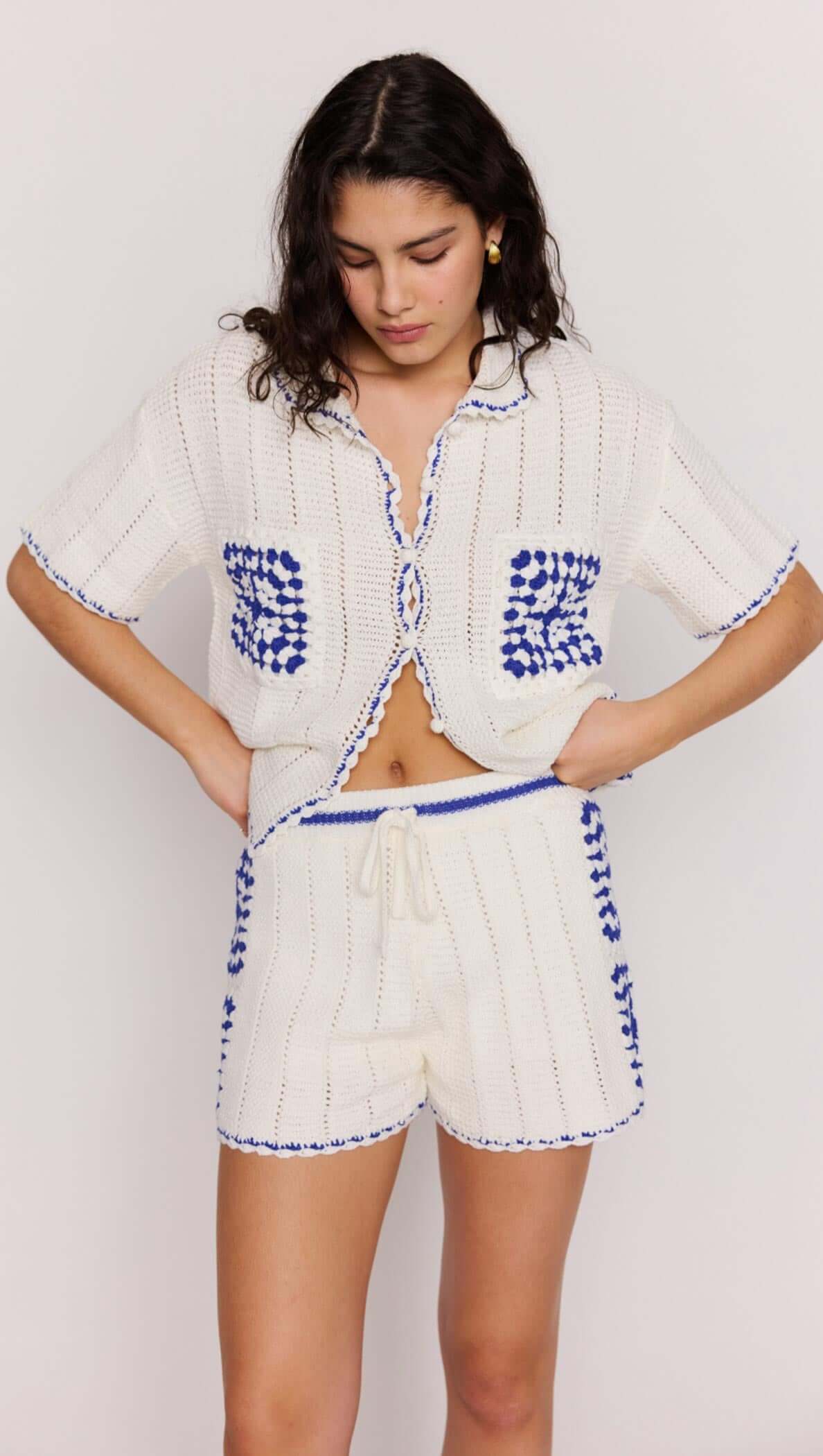 Model wearing Blue & White Cotton Crochet Knit Shorts paired with a matching crochet shirt, showcasing a relaxed summer look.