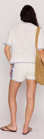 Model wearing Blue & White Cotton Crochet Knit Shorts with matching crochet top and tote bag.
