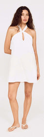 Model wearing a Broderie Anglaise Cotton Mini Dress with a halter neck and keyhole detail in white.
