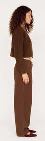 Brown Cropped Cardigan with Gold Button Detail worn by a model, showcasing a side view and styled with matching brown pants.