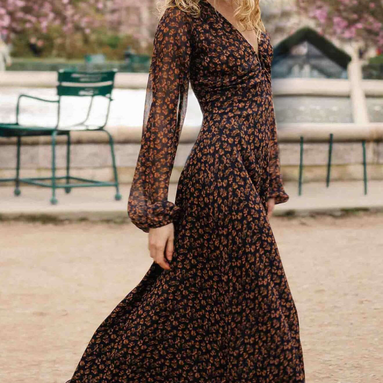 Brown Floral Drape Sleeve Maxi Dress modeled outdoors with a flowing silhouette and drape sleeves.