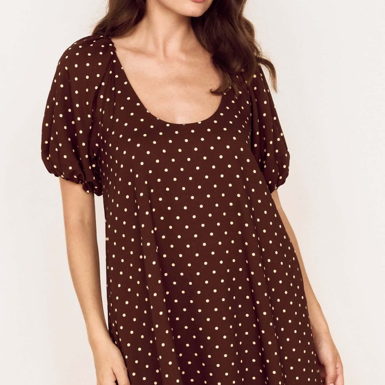 Brown Linen Blend Polka Dot Puff Sleeve Mini Dress worn by a model, featuring puff sleeves and a scoop neckline.