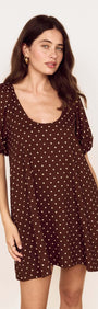 Brown Linen Blend Polka Dot Puff Sleeve Mini Dress worn by a model, featuring puff sleeves and a scoop neckline.