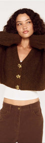 Brown Cropped Cardigan with Gold Button Detail modeled by a woman with curly hair, showcasing a textured knit design.